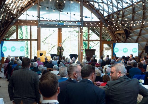a woman speaking at a conference